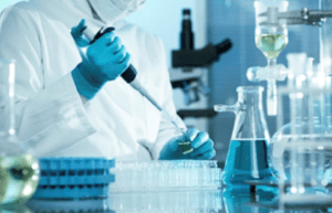 Person putting liquid on a small bottle in the lab